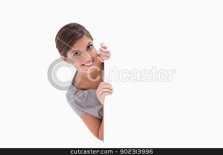 To use this stock image in your creative project, please select the size you need over to the right and click the "Add to Cart" button.
Your downloaded image will come with the Cutcaster watermark removed so don’t worry about the watermark you see on this page. Smiling woman looking around the corner stock photo, Smiling woman looking around the corner against a white background by Wavebreak Media