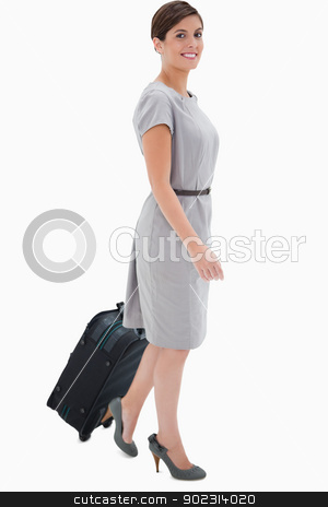 To use this stock image in your creative project, please select the size you need over to the right and click the "Add to Cart" button.
Your downloaded image will come with the Cutcaster watermark removed so don’t worry about the watermark you see on this page. Side view of smiling woman with wheely bag stock photo, Side view of smiling woman with wheely bag against a white background by Wavebreak Media
