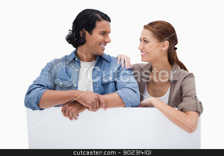 To use this stock image in your creative project, please select the size you need over to the right and click the "Add to Cart" button.
Your downloaded image will come with the Cutcaster watermark removed so don’t worry about the watermark you see on this page. Smiling couple leaning on blank wall stock photo, Smiling couple leaning on blank wall against a white background by Wavebreak Media