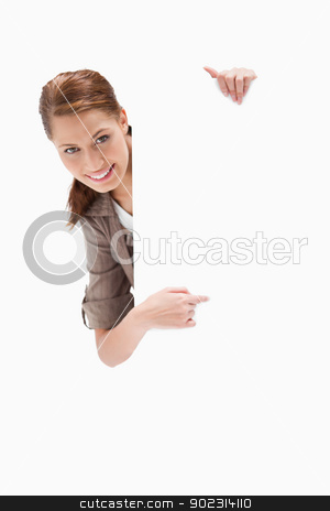 To use this stock image in your creative project, please select the size you need over to the right and click the "Add to Cart" button.
Your downloaded image will come with the Cutcaster watermark removed so don’t worry about the watermark you see on this page. Smiling woman pointing around blank sign stock photo, Smiling woman pointing around blank sign against a white background by Wavebreak Media