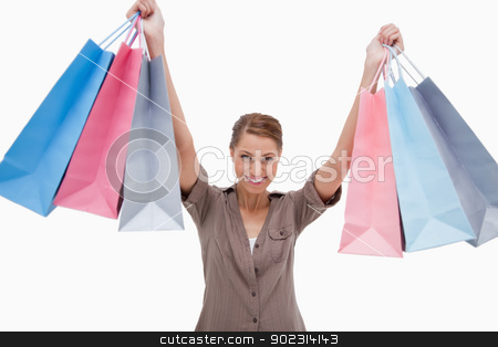 To use this stock image in your creative project, please select the size you need over to the right and click the "Add to Cart" button.
Your downloaded image will come with the Cutcaster watermark removed so don’t worry about the watermark you see on this page. Smiling woman raising her shopping bags stock photo, Smiling woman raising her shopping bags against a white background by Wavebreak Media