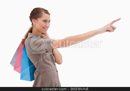 To use this stock image in your creative project, please select the size you need over to the right and click the "Add to Cart" button.
Your downloaded image will come with the Cutcaster watermark removed so don’t worry about the watermark you see on this page. Side view of pointing woman with shopping bags stock photo, Side view of pointing woman with shopping bags against a white background by Wavebreak Media