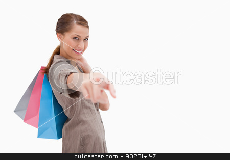To use this stock image in your creative project, please select the size you need over to the right and click the "Add to Cart" button.
Your downloaded image will come with the Cutcaster watermark removed so don’t worry about the watermark you see on this page. Side view of smiling woman pointing with shopping bags stock photo, Side view of smiling woman pointing with shopping bags against a white background by Wavebreak Media