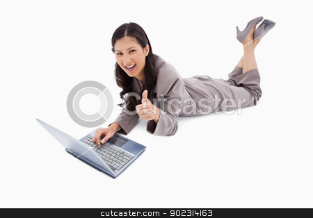 To use this stock image in your creative project, please select the size you need over to the right and click the "Add to Cart" button.
Your downloaded image will come with the Cutcaster watermark removed so don’t worry about the watermark you see on this page. Lying woman with laptop giving thumb up stock photo, Lying woman with laptop giving thumb up against a white background by Wavebreak Media
