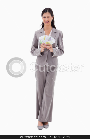 To use this stock image in your creative project, please select the size you need over to the right and click the "Add to Cart" button.
Your downloaded image will come with the Cutcaster watermark removed so don’t worry about the watermark you see on this page. Smiling businesswoman holding money stock photo, Smiling businesswoman holding money against a white background by Wavebreak Media