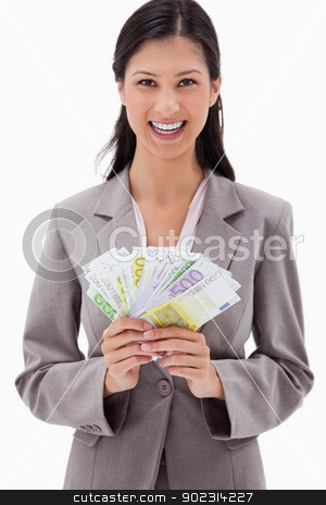 To use this stock image in your creative project, please select the size you need over to the right and click the "Add to Cart" button.
Your downloaded image will come with the Cutcaster watermark removed so don’t worry about the watermark you see on this page. Smiling businesswoman with bank notes in her hands stock photo, Smiling businesswoman with bank notes in her hands against a white background by Wavebreak Media