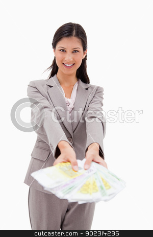 To use this stock image in your creative project, please select the size you need over to the right and click the "Add to Cart" button.
Your downloaded image will come with the Cutcaster watermark removed so don’t worry about the watermark you see on this page. Smiling businesswoman offering money stock photo, Smiling businesswoman offering money against a white background by Wavebreak Media