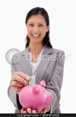 To use this stock image in your creative project, please select the size you need over to the right and click the "Add to Cart" button.
Your downloaded image will come with the Cutcaster watermark removed so don’t worry about the watermark you see on this page. Money being put into piggy bank by smiling businesswoman stock photo, Money being put into piggy bank by smiling businesswoman against a white background by Wavebreak Media