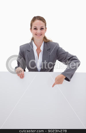 To use this stock image in your creative project, please select the size you need over to the right and click the "Add to Cart" button.
Your downloaded image will come with the Cutcaster watermark removed so don’t worry about the watermark you see on this page. Smiling bank employee pointing down at blank sign stock photo, Smiling bank employee pointing down at blank sign against a white background by Wavebreak Media