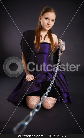 To use this stock image in your creative project, please select the size you need over to the right and click the "Add to Cart" button.
Your downloaded image will come with the Cutcaster watermark removed so don’t worry about the watermark you see on this page. Young beautiful girl pulls out a chain leash stock photo, Young beautiful girl pulls out a chain leash on black background by Alexey Romanov