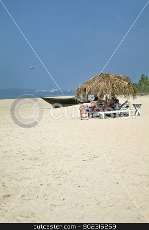 To use this stock image in your creative project, please select the size you need over to the right and click the "Add to Cart" button.
Your downloaded image will come with the Cutcaster watermark removed so don’t worry about the watermark you see on this page. Holidaymakers under coconut huts on secluded be stock photo, Portrait of secluded beach close of a city with dayt rippers and holidaymakers under the shade of coconut parasols. White sand, blue sky, sea, surf, para glider and fishing boats for a backdrop. Generic tropical shot location, Goa India by Kantilal Patel