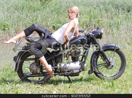 To use this stock image in your creative project, please select the size you need over to the right and click the "Add to Cart" button.
Your downloaded image will come with the Cutcaster watermark removed so don’t worry about the watermark you see on this page. Young woman on motorcycle stock photo, Fashionably dressed woman seated on an old motorcycle by Roland Stollner