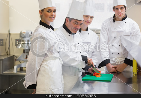 To use this stock image in your creative project, please select the size you need over to the right and click the "Add to Cart" button.
Your downloaded image will come with the Cutcaster watermark removed so don’t worry about the watermark you see on this page. Trainee Chef's learning to cut vegetables stock photo, Trainne Chef's learning to cut vegetables and smiling in the kitchen by Wavebreak Media