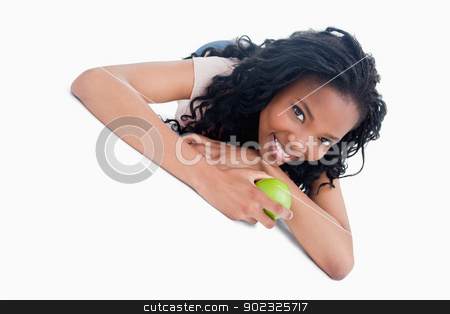To use this stock image in your creative project, please select the size you need over to the right and click the "Add to Cart" button.
Your downloaded image will come with the Cutcaster watermark removed so don’t worry about the watermark you see on this page. A young girl lying on the ground holding an apple stock photo, A young girl is lying on the floor holding a green apple against a white background by Wavebreak Media