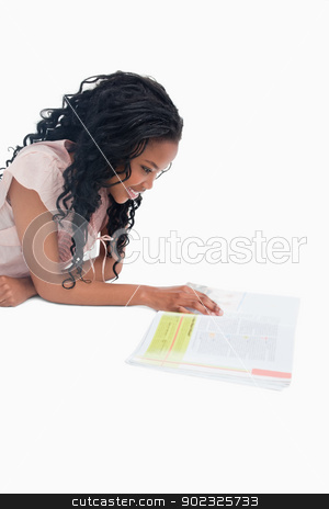 To use this stock image in your creative project, please select the size you need over to the right and click the "Add to Cart" button.
Your downloaded image will come with the Cutcaster watermark removed so don’t worry about the watermark you see on this page. A side shot of a woman lying on the floor reading a book stock photo, A side shot of a young woman lying on the floor reading a book against a white background by Wavebreak Media
