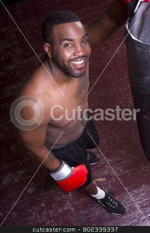 To use this stock image in your creative project, please select the size you need over to the right and click the "Add to Cart" button.
Your downloaded image will come with the Cutcaster watermark removed so don’t worry about the watermark you see on this page. Happy Boxer Pauses at Heavy Bag stock photo, A boxer pauses and looks up at the camera by Christopher Boswell