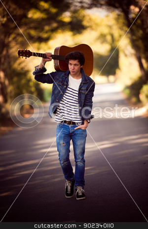 To use this stock image in your creative project, please select the size you need over to the right and click the "Add to Cart" button.
Your downloaded image will come with the Cutcaster watermark removed so don’t worry about the watermark you see on this page. man with guitar stock photo, drifter, man with guitar walking outdoors by mandygodbehear