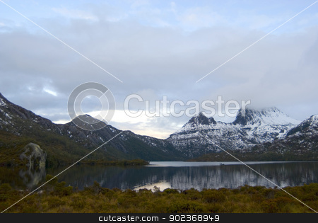 To use this stock image in your creative project, please select the size you need over to the right and click the "Add to Cart" button.
Your downloaded image will come with the Cutcaster watermark removed so don’t worry about the watermark you see on this page. Cradle Mountain in winter stock photo, Cradle Mountain in Tasmania covered in winter snow reflected in the still water of the lake below by Stephen Gibson