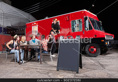 To use this stock image in your creative project, please select the size you need over to the right and click the "Add to Cart" button.
Your downloaded image will come with the Cutcaster watermark removed so don’t worry about the watermark you see on this page. Happy Customers at Food Truck stock photo, Happy diners at food truck with blank sign by Scott Griessel