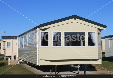 To use this stock image in your creative project, please select the size you need over to the right and click the "Add to Cart" button.
Your downloaded image will come with the Cutcaster watermark removed so don’t worry about the watermark you see on this page. Exterior of modern static caravan stock photo, Exterior of modern static caravan in trailer park, England. by Martin Crowdy