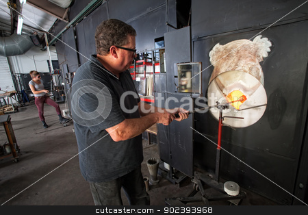 To use this stock image in your creative project, please select the size you need over to the right and click the "Add to Cart" button.
Your downloaded image will come with the Cutcaster watermark removed so don’t worry about the watermark you see on this page. Man Working at Kiln stock photo, Male glass artist putting object in hot kiln by Scott Griessel