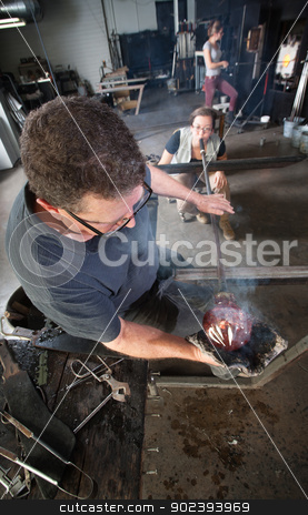 To use this stock image in your creative project, please select the size you need over to the right and click the "Add to Cart" button.
Your downloaded image will come with the Cutcaster watermark removed so don’t worry about the watermark you see on this page. Workers Making Fine Art Glass stock photo, Craftsman working with assistant to create fine art glass by Scott Griessel