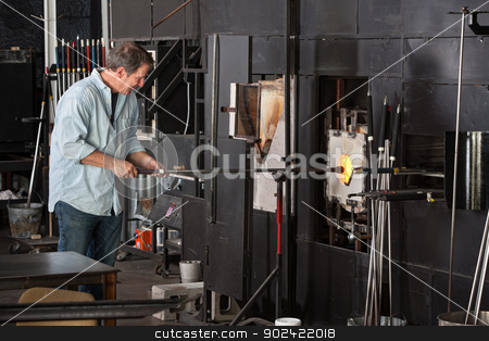 To use this stock image in your creative project, please select the size you need over to the right and click the "Add to Cart" button.
Your downloaded image will come with the Cutcaster watermark removed so don’t worry about the watermark you see on this page. Man Working with Kiln stock photo, European male working with kiln in glass manufacturing business by Scott Griessel