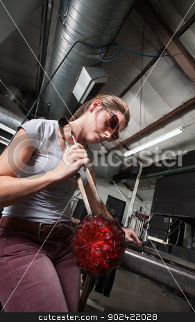 To use this stock image in your creative project, please select the size you need over to the right and click the "Add to Cart" button.
Your downloaded image will come with the Cutcaster watermark removed so don’t worry about the watermark you see on this page. Female Glass Worker with Object stock photo, Serious Caucasian artist with tongs and decorative glass object by Scott Griessel