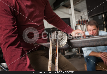 To use this stock image in your creative project, please select the size you need over to the right and click the "Add to Cart" button.
Your downloaded image will come with the Cutcaster watermark removed so don’t worry about the watermark you see on this page. Men Creating Clear Glass Object stock photo, Man blowing into pipe for clear glass object by Scott Griessel