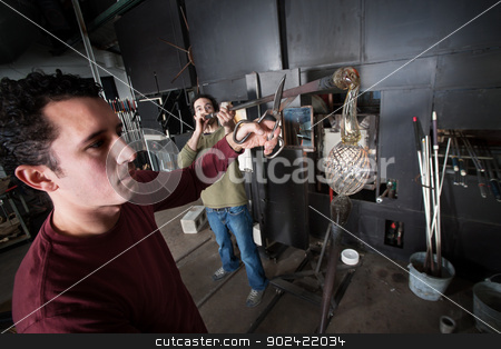To use this stock image in your creative project, please select the size you need over to the right and click the "Add to Cart" button.
Your downloaded image will come with the Cutcaster watermark removed so don’t worry about the watermark you see on this page. Students Working with Glass Art stock photo, Two glass art students forming fine art glass object by Scott Griessel