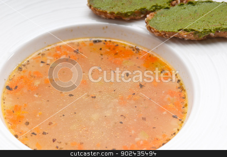 To use this stock image in your creative project, please select the size you need over to the right and click the "Add to Cart" button.
Your downloaded image will come with the Cutcaster watermark removed so don’t worry about the watermark you see on this page. Italian minestrone soup with pesto crostini on side stock photo, classic Italian minestrone