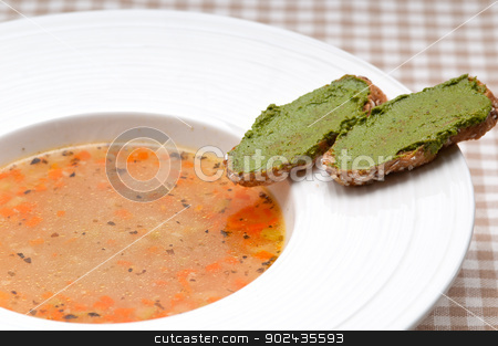 To use this stock image in your creative project, please select the size you need over to the right and click the "Add to Cart" button.
Your downloaded image will come with the Cutcaster watermark removed so don’t worry about the watermark you see on this page. Italian minestrone soup with pesto crostini on side stock photo, classic Italian minestrone