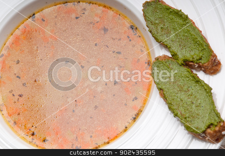 To use this stock image in your creative project, please select the size you need over to the right and click the "Add to Cart" button.
Your downloaded image will come with the Cutcaster watermark removed so don’t worry about the watermark you see on this page. Italian minestrone soup with pesto crostini on side stock photo, classic Italian minestrone