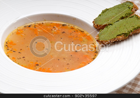 To use this stock image in your creative project, please select the size you need over to the right and click the "Add to Cart" button.
Your downloaded image will come with the Cutcaster watermark removed so don’t worry about the watermark you see on this page. Italian minestrone soup with pesto crostini on side stock photo, classic Italian minestrone