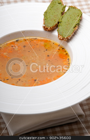 To use this stock image in your creative project, please select the size you need over to the right and click the "Add to Cart" button.
Your downloaded image will come with the Cutcaster watermark removed so don’t worry about the watermark you see on this page. Italian minestrone soup with pesto crostini on side stock photo, classic Italian minestrone