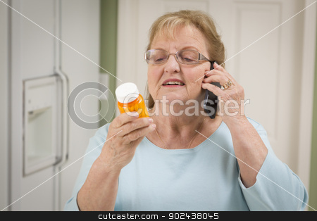 To use this stock image in your creative project, please select the size you need over to the right and click the "Add to Cart" button.
Your downloaded image will come with the Cutcaster watermark removed so don’t worry about the watermark you see on this page. Senior Adult Woman on Cell Phone Holding Prescription Bottle stock photo, Beautiful Senior Adult Woman in Kitchen on Her Cell Phone Holding Prescription Bottle. by Andy Dean