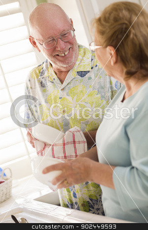 To use this stock image in your creative project, please select the size you need over to the right and click the "Add to Cart" button.
Your downloaded image will come with the Cutcaster watermark removed so don’t worry about the watermark you see on this page. Senior Adult Couple Washing Dishes Together Inside Kitchen stock photo, Senior Adult Couple Having Fun Washing Dishes Together Inside Kitchen of Their House. by Andy Dean