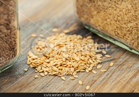 To use this stock image in your creative project, please select the size you need over to the right and click the "Add to Cart" button.
Your downloaded image will come with the Cutcaster watermark removed so don’t worry about the watermark you see on this page. gold flax seeds stock photo, gold flax seeds on a wood background, a small pile and glass jars with a selective focus by Marek Uliasz
