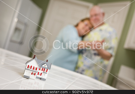 To use this stock image in your creative project, please select the size you need over to the right and click the "Add to Cart" button.
Your downloaded image will come with the Cutcaster watermark removed so don’t worry about the watermark you see on this page. Senior Adult Couple Gazing Over Small Model Home on Counter stock photo, Happy Senior Adult Couple Dancing Together and Gazing Over Small Model Home on Their Kitchen Counter. by Andy Dean