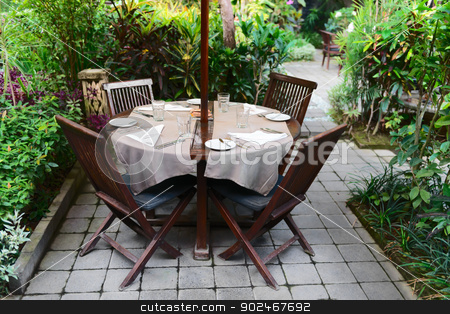 To use this stock image in your creative project, please select the size you need over to the right and click the "Add to Cart" button.
Your downloaded image will come with the Cutcaster watermark removed so don’t worry about the watermark you see on this page. Outdoor cafe in a green garden stock photo, Summer outdoor cafe in a green garden by Iryna Rasko