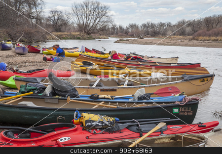 To use this stock image in your creative project, please select the size you need over to the right and click the "Add to Cart" button.
Your downloaded image will come with the Cutcaster watermark removed so don’t worry about the watermark you see on this page. Kayaks and canoes stock photo, SOUTH PLATTE RIVER, EVANS, COLORADO - APRIL 6: Kayaks and canoes on a river shore during Annual All Club Paddle on April 6, 2013. It is a popular season opening paddling trip in northern Colorado. by Marek Uliasz