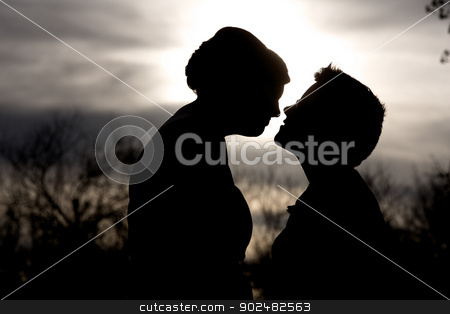 To use this stock image in your creative project, please select the size you need over to the right and click the "Add to Cart" button.
Your downloaded image will come with the Cutcaster watermark removed so don’t worry about the watermark you see on this page. Intimate Couple Silhouette stock photo, Back lit lesbian couple close together outdoors by Scott Griessel