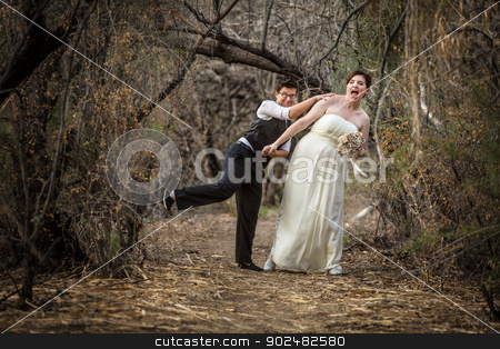 To use this stock image in your creative project, please select the size you need over to the right and click the "Add to Cart" button.
Your downloaded image will come with the Cutcaster watermark removed so don’t worry about the watermark you see on this page. Newlyweds Playing in Forest stock photo, Bride and groom playing together in forest by Scott Griessel