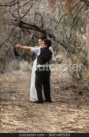 To use this stock image in your creative project, please select the size you need over to the right and click the "Add to Cart" button.
Your downloaded image will come with the Cutcaster watermark removed so don’t worry about the watermark you see on this page. Sweethearts Dancing in Woods stock photo, Happy lesbian newlyweds dancing together in forest
by Scott Griessel