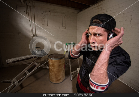 To use this stock image in your creative project, please select the size you need over to the right and click the "Add to Cart" button.
Your downloaded image will come with the Cutcaster watermark removed so don’t worry about the watermark you see on this page. Cool Hip Hop Artist stock photo, European hip hop guy with backwards cap and earphones by Scott Griessel