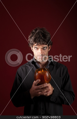 To use this stock image in your creative project, please select the size you need over to the right and click the "Add to Cart" button.
Your downloaded image will come with the Cutcaster watermark removed so don’t worry about the watermark you see on this page. Wizard Holding Candle stock photo, Wizard holds candle with both hands over maroon background by Scott Griessel