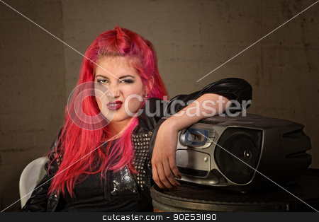 To use this stock image in your creative project, please select the size you need over to the right and click the "Add to Cart" button.
Your downloaded image will come with the Cutcaster watermark removed so don’t worry about the watermark you see on this page. Woman Curling Her Lip stock photo, Bored girl with pink hair and radio curling her lip by Scott Griessel