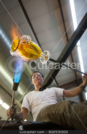 To use this stock image in your creative project, please select the size you need over to the right and click the "Add to Cart" button.
Your downloaded image will come with the Cutcaster watermark removed so don’t worry about the watermark you see on this page. Artist Creating a Vase stock photo, Industrial artist creating a yellow glass vase by Scott Griessel