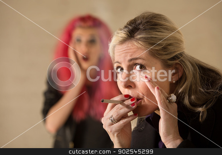 To use this stock image in your creative project, please select the size you need over to the right and click the "Add to Cart" button.
Your downloaded image will come with the Cutcaster watermark removed so don’t worry about the watermark you see on this page. Woman Sneaking a Cigarette stock photo, Surprised teen behind mature woman smoking a cigarette by Scott Griessel