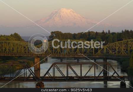 To use this stock image in your creative project, please select the size you need over to the right and click the "Add to Cart" button.
Your downloaded image will come with the Cutcaster watermark removed so don’t worry about the watermark you see on this page. Railroad and Car Bridges over Puyallup River Mt. Rainier Washing stock photo, The Puyallup River meanders down from the glaciers on Mount Rainier under bridges through cities on it's way to Puget Sound by Christopher Boswell